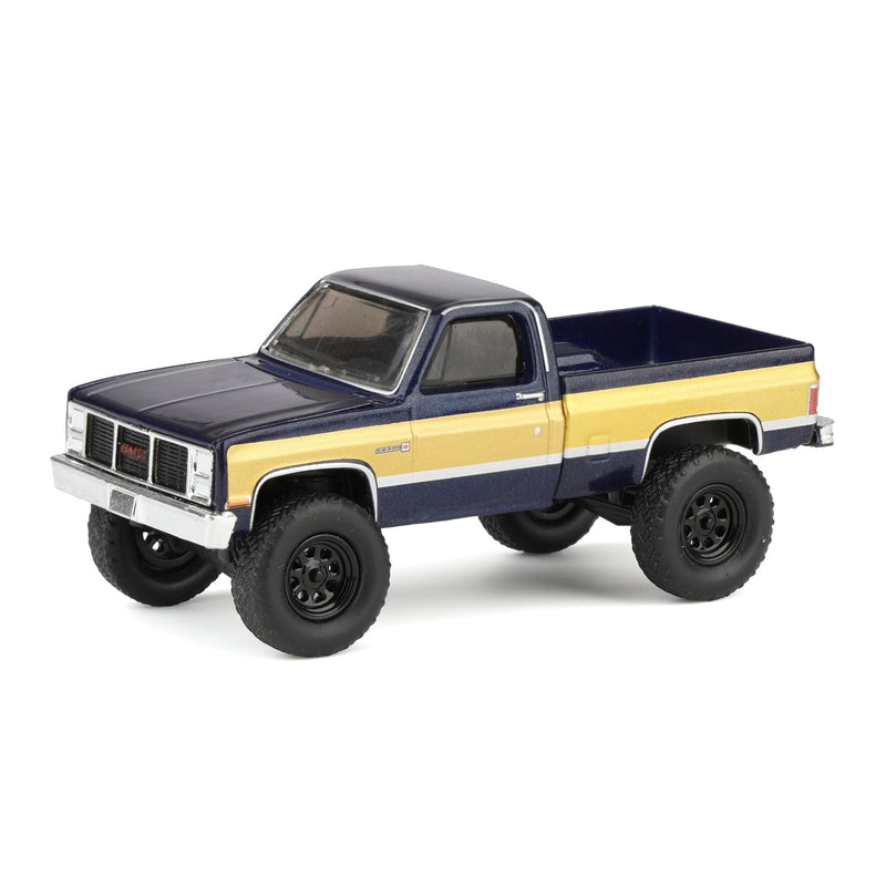 1/64 Lifted 1987 GMC K2500 High Sierra Pickup Truck, Stone Blue Metallic & Gold Dealer Exclusive by GreenLight Collectibles