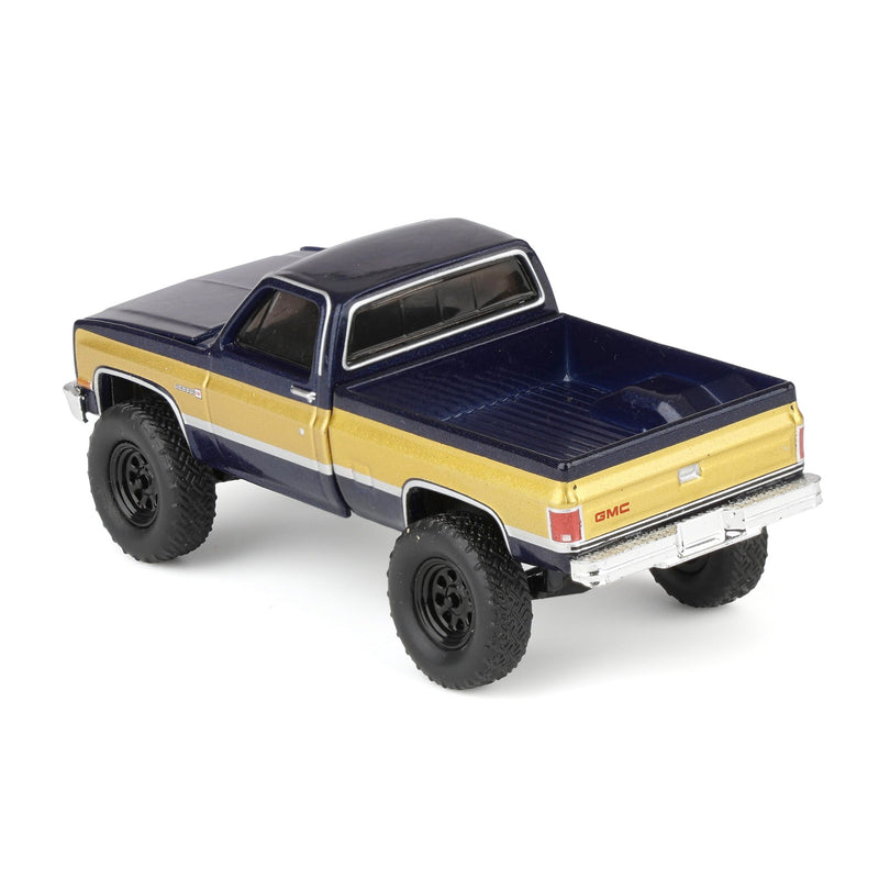 1/64 Lifted 1987 GMC K2500 High Sierra Pickup Truck, Stone Blue Metallic & Gold Dealer Exclusive by GreenLight Collectibles
