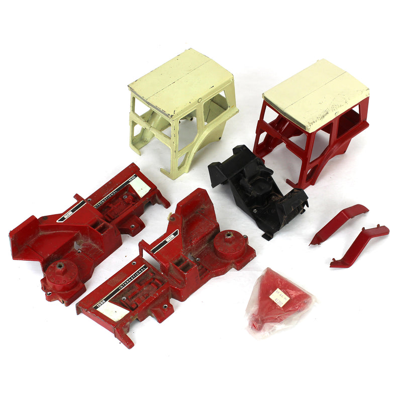 Lot of Miscellaneous IH Tractor Parts Including (2) Tractor Cabs, (1)Cab Interior, (2) Body Halves to a IH 1586 Tractor, and (2) Flat Top Fenders